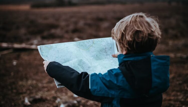 6 Big Cities to Explore With Your Children - a photo of a child holding a map